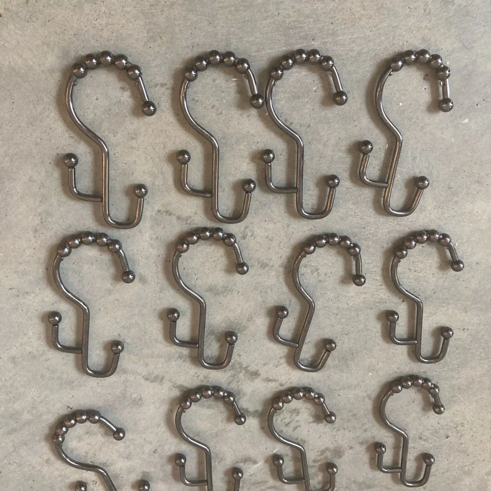 12 industrial style pewter shower curtain hooks. Perfect never used.